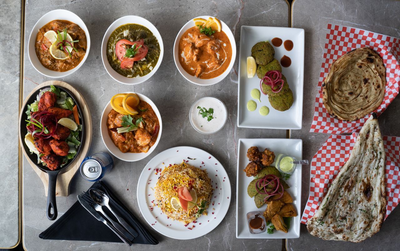 services-03 A diverse selection of Indian dishes beautifully arranged in an overhead view.
